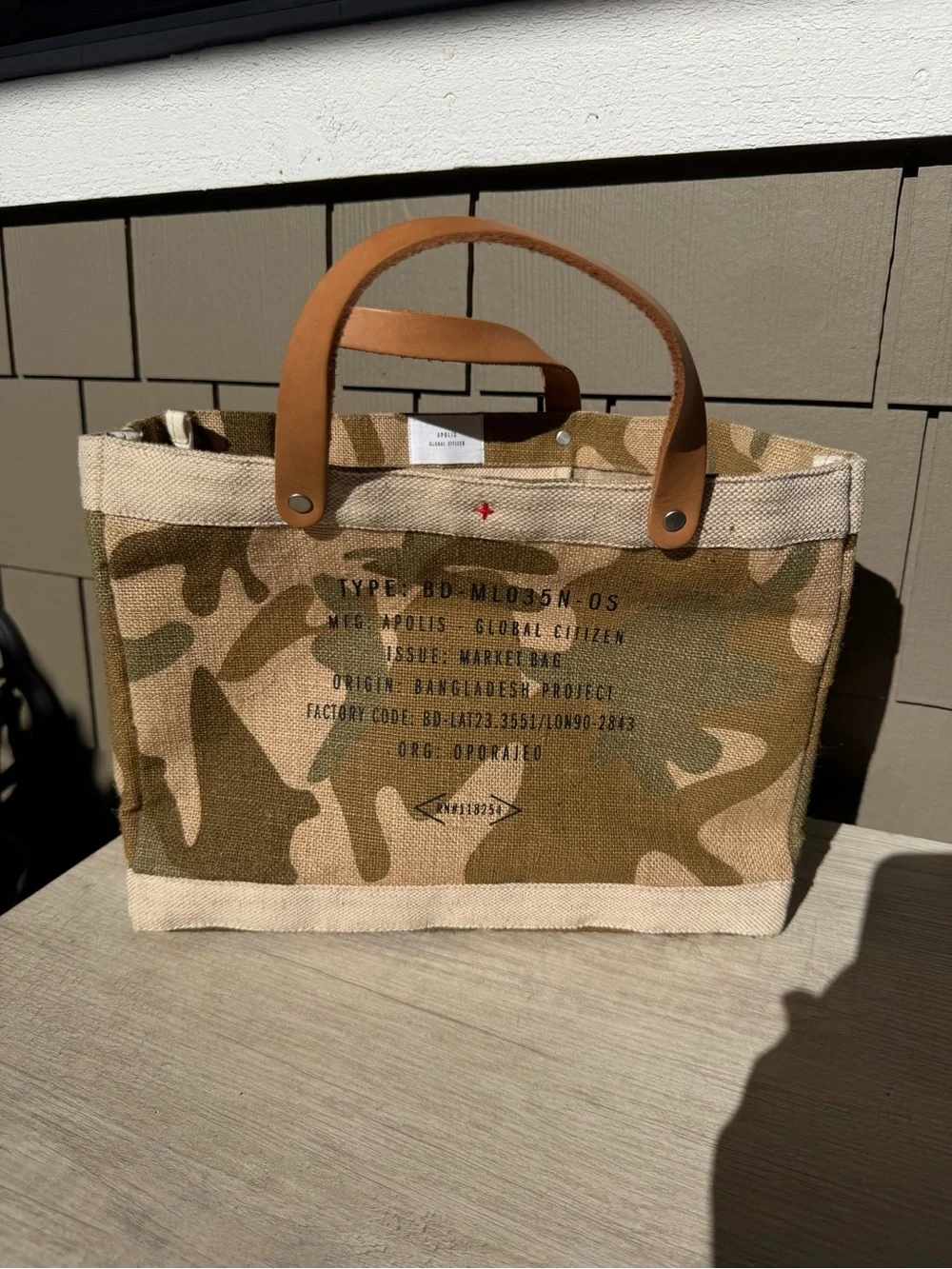 Apolis Global Citizen Market Bag in a safari camo print with tan leather handles